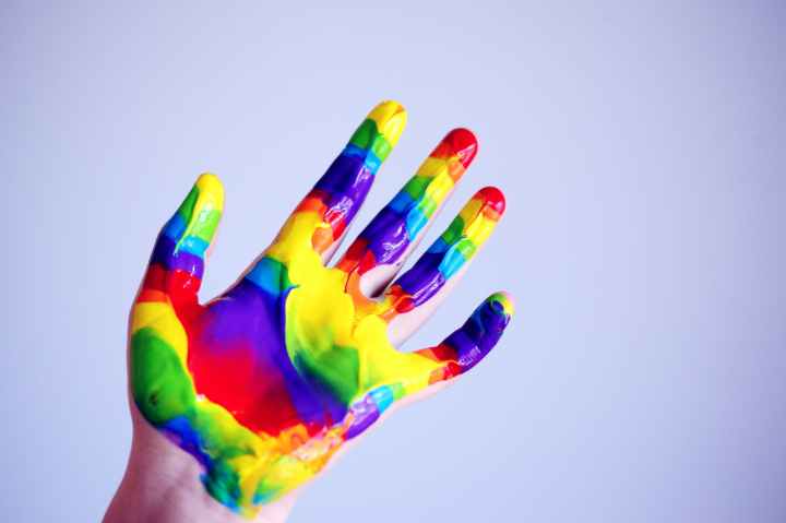 person s hand with paints